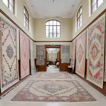 Quality inspection area at MirzapurLooms performing comprehensive twenty-three point inspection checking knot density color consistency pattern alignment before final approval for shipping